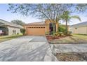 Inviting single-story home with a well-maintained lawn, mature trees, and a spacious two-car garage at 2340 Lawrence Hall St, Ruskin, FL 33570