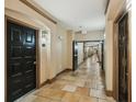 Neutral hallway showcasing tile floors leading to doors in a multi-Gathering building at 4221 W Spruce St # 1414, Tampa, FL 33607