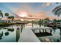 Beautiful waterfront view featuring a private dock, serene water reflections, and stunning sunset ambiance at 4807 Wynwood Dr, Tampa, FL 33615