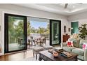 Living room featuring sliding glass doors to the outdoor patio, comfortable seating, and stylish decor at 58 Inness Dr, Tarpon Springs, FL 34689