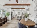 Cozy dining area showcasing wooden beams, luxury vinyl plank flooring, and seamlessly connected to the kitchen at 605 12Th N Ave, St Petersburg, FL 33701