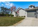 Beautiful home with a well-maintained lawn, neutral paint, an American flag, and an attached one-car garage at 7536 Roland Ct, New Port Richey, FL 34654