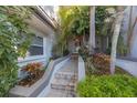 Inviting entryway with brick steps and lush tropical landscaping at 903 Pinellas Bayway S # 307, Tierra Verde, FL 33715