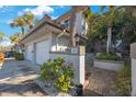 Townhome exterior features manicured landscaping, tile roof, and private entry at 903 Pinellas Bayway S # 307, Tierra Verde, FL 33715