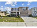 Two-story home with neutral colors, black shutters, stone accents, a covered porch and a two-car garage at 12326 Dora Trl, Parrish, FL 34219