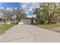 Charming single-story home with a long driveway and lush tropical landscaping in the front yard at 13815 Capitol Dr, Tampa, FL 33613