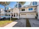 Townhome exteriors showing crisp white facade, attached garages, and well-manicured lawns on a sunny day at 14700 Seminole Trl, Seminole, FL 33776