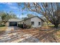 Charming home featuring stone accents, a well-maintained yard, and a spacious driveway at 16106 Blackbeard Ln, Hudson, FL 34667