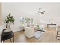 Airy living room featuring plenty of natural light from large windows and neutral, modern furniture at 1624 Barry Rd, Clearwater, FL 33756