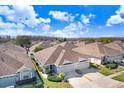 Aerial shot of the single story home with a well manicured lawn and neighborhood at 19131 Weymouth Dr, Land O Lakes, FL 34638