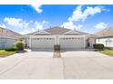 Attached single story homes featuring attached garages and well-manicured landscaping at 19131 Weymouth Dr, Land O Lakes, FL 34638