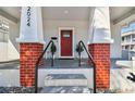 Inviting front porch with brick columns and a red front door at 2024 E Columbus Dr, Tampa, FL 33605