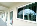 Exterior building hallway with access to units, featuring neutral paint and consistent architectural design at 2434 Australia E Way # 44, Clearwater, FL 33763