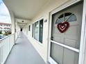 Exterior hallway features smooth flooring, arched supports, and views of the community at 2434 Australia E Way # 44, Clearwater, FL 33763