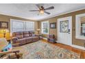 Cozy living room featuring hardwood floors, a plush sofa, and ample natural light at 2885 18Th N Ave, St Petersburg, FL 33713