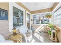 Inviting enclosed porch featuring large windows, tile flooring, and comfortable seating at 2885 18Th N Ave, St Petersburg, FL 33713