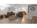 Cozy living room featuring modern furniture, neutral walls, and hardwood floors, creating a warm and inviting atmosphere at 4077 Ramona Dr, Spring Hill, FL 34606