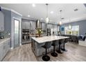 Gourmet kitchen boasting a large center island, modern appliances, and a breakfast nook at 6326 Brevada Ln, Apollo Beach, FL 33572