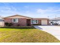 Charming brick home with a well-maintained lawn and inviting curb appeal at 6518 Leeside Isle, Hudson, FL 34667