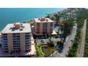 Aerial view of condo buildings with waterfront views and lush landscaping at 7432 Sunshine Skyway S Ln # 206, St Petersburg, FL 33711