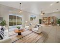 Inviting living room with neutral tones, tile flooring, and sliding glass doors to the outdoors at 9003 Willowbrook Cir, Bradenton, FL 34212