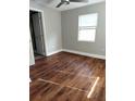 A bright bedroom features hardwood floors, a ceiling fan, and a sunny window at 910 Seminole St, Clearwater, FL 33755