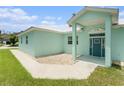 Beautiful home with blue front door, light-blue accents, and gravel landscaping at 9321 Regatta Cir, Spring Hill, FL 34606