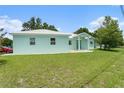 Charming single-story home with vibrant light-blue exterior and well-maintained front yard at 9321 Regatta Cir, Spring Hill, FL 34606