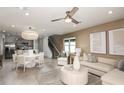 Bright and airy living room showcasing neutral decor, an open floorplan, recessed lighting, and seamless transition to dining area at 9802 Crescent Moon Dr, Riverview, FL 33578