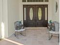 Elegant double front doors with decorative glass accents, complemented by outdoor seating at 1011 Riverside Ridge Rd, Tarpon Springs, FL 34688