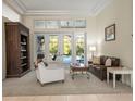 Comfortable living room with neutral tones, large windows, and access to the outdoor area at 1011 Riverside Ridge Rd, Tarpon Springs, FL 34688