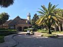 Beautiful clubhouse exterior with brick facade, lush landscaping, and a charming lighthouse feature at 10200 Gandy N Blvd # 209, St Petersburg, FL 33702