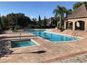 Resort-style community pool featuring a large pool, jacuzzi, and ample seating for residents at 10200 Gandy N Blvd # 209, St Petersburg, FL 33702