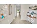 Bright entryway featuring neutral paint, tiled flooring, and decorative accents at 11842 Davis Dr, Largo, FL 33774