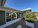 Welcoming front entry featuring a brick walkway and decorative greenery at 14132 89Th Ave, Seminole, FL 33776