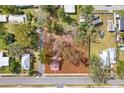 Aerial view of a property with a square lot and surrounding neighborhood homes at 14329 14Th St, Dade City, FL 33523