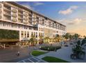 Upscale building with street-level shops, greenery, and pedestrian walkways for an urban lifestyle at 15000 Madeira Way # 622, Madeira Beach, FL 33708