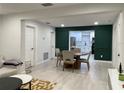 This spacious dining area opens to a modern kitchen and has a decorative green accent wall at 2613 E 23Rd Ave, Tampa, FL 33605