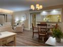Open-concept living room with wood floors, neutral color scheme, and a view into the kitchen at 36750 Us Highway 19 N # 6-109, Palm Harbor, FL 34684