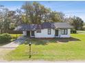 Inviting single-story home featuring a covered carport and lush green lawn at 38638 2Nd Ave, Zephyrhills, FL 33542