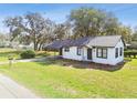 Delightful single-story home with a carport and a well-manicured lawn and landscape at 38638 2Nd Ave, Zephyrhills, FL 33542