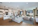 Bright, open-concept living room with hardwood floors, stylish furniture, and a view of the backyard at 4209 Big Sky Dr, Spring Hill, FL 34604