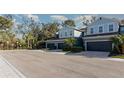 View of townhomes in a quiet community with sidewalks and lush landscaping at 4549 Chinkapin Dr, Sarasota, FL 34232