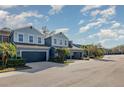 Street view showcasing a row of modern townhomes with well-maintained landscaping and driveways at 4549 Chinkapin Dr, Sarasota, FL 34232