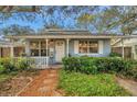 Inviting single-story home with a covered front porch and well-maintained landscaping at 5036 18Th N St, St Petersburg, FL 33714