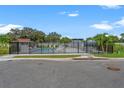 The community pool features a secure fence, palm trees, and lounge chairs for relaxation at 6213 64Th N Way, Pinellas Park, FL 33781