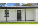 Close-up of the front door with a decorative window and the house number clearly displayed at 6291 63Rd N St, Pinellas Park, FL 33781