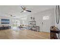 Bright, open-concept living room with hardwood floors and modern ceiling fans at 6291 63Rd N St, Pinellas Park, FL 33781