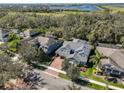 Aerial view of home with large brick driveway and a large pond in the distance at 6640 Park Strand Dr, Apollo Beach, FL 33572