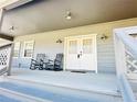 Inviting covered porch with rocking chairs, perfect for relaxing and enjoying the outdoors at 7705 W Four Pines Rd, Plant City, FL 33565